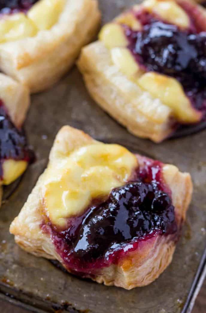 Cheesy Puff Pastry Bites with blueberry jam and goat cheese.
