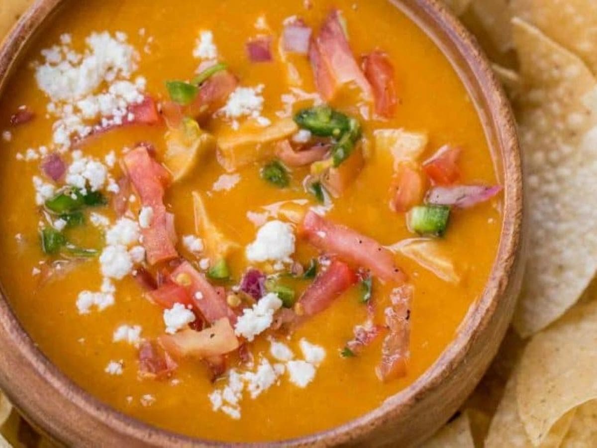 Enchilada soup in a bowl with chips.