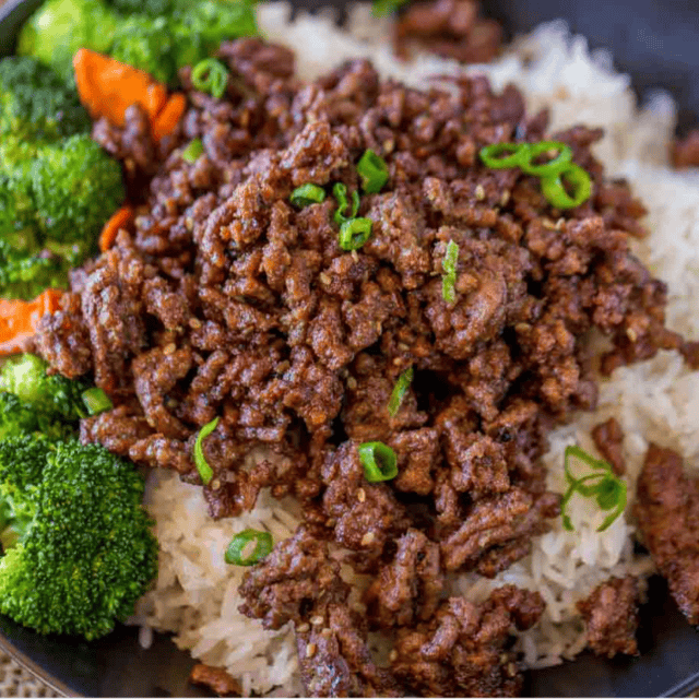 Beef and veggies over rice in blue bowl
