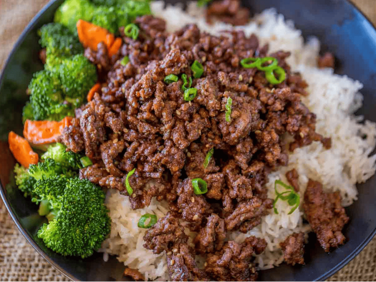 Beef and veggies over rice in blue bowl