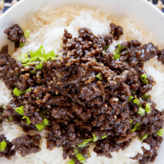ground beef on top off rice in a white bowl