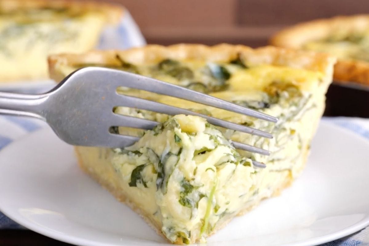 Spinach Quiche (Quiche Florentine) slice on plate with fork