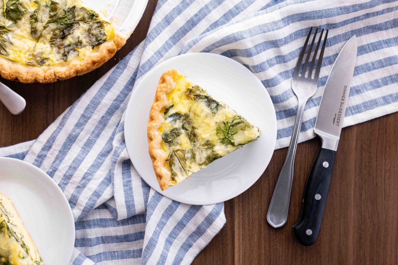 Spinach Quiche (Quiche Florentine) slice on plate with knife and fork