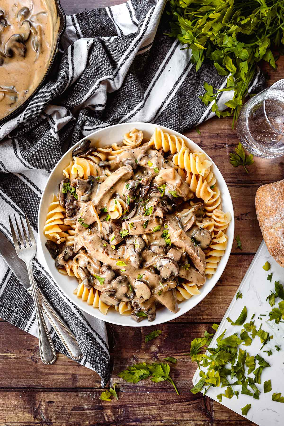 Beef Stroganoff steak with creamy mushroom gravy over egg pasta in bowl