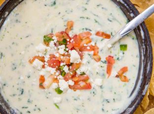 White Spinach Queso in pan with chips