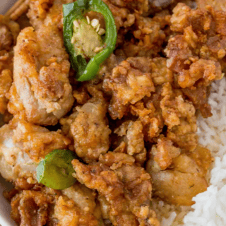 Bowl of crispy fried chicken pieces over rice