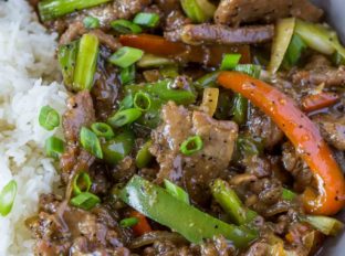 Chinese Pepper Steak in bowl with rice
