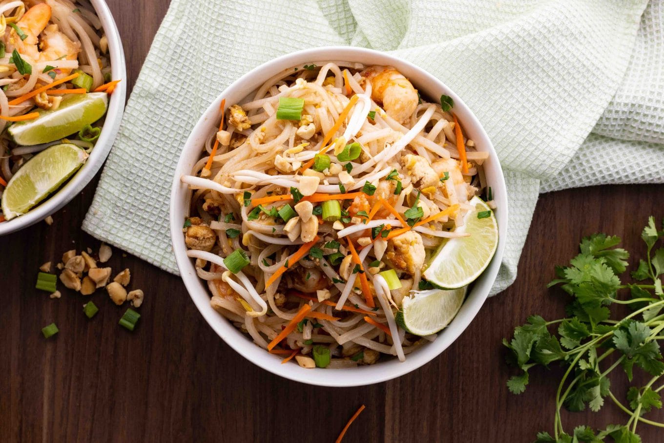 Pad Thai in bowl with lime wedges