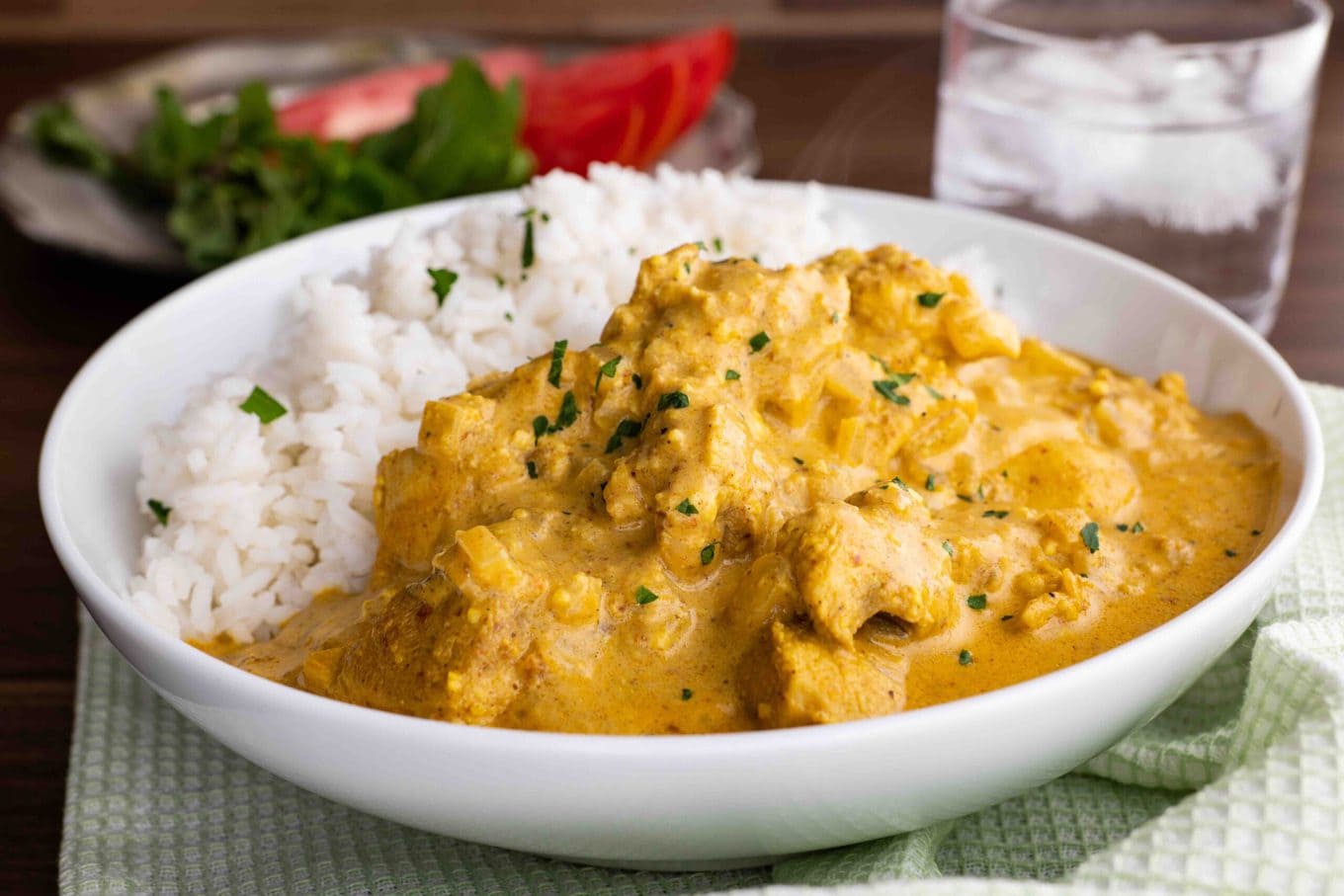 Indian Chicken Korma with rice in bowl