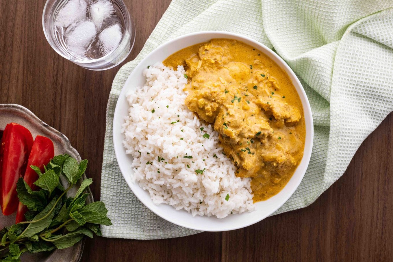 Indian Chicken Korma with rice in bowl