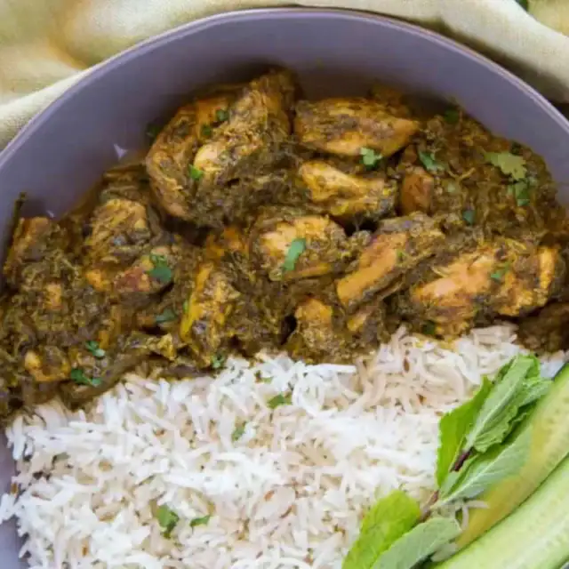 Chicken served on plate with rice