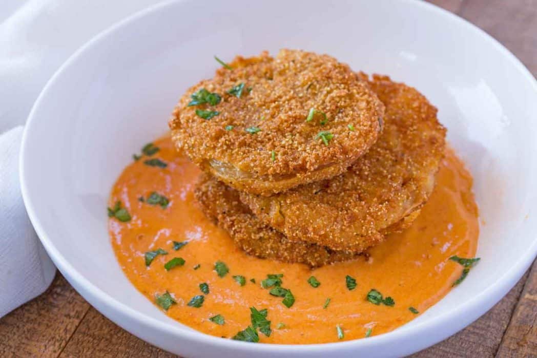 Fried Green Tomatoes in orange sauce shot at an angle