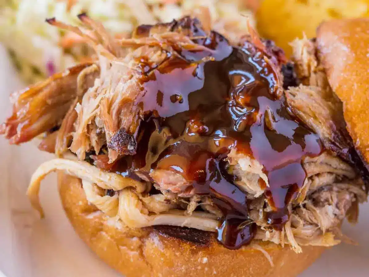 shredded pork with bbq sauce on a bun 