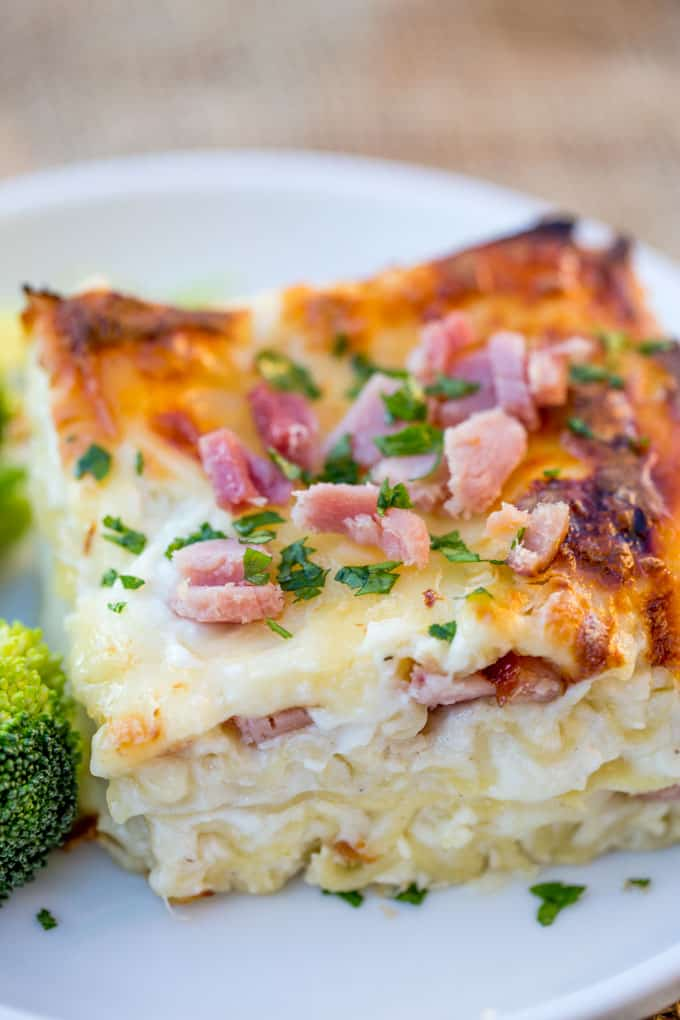 Square of chicken lasagna served with broccoli
