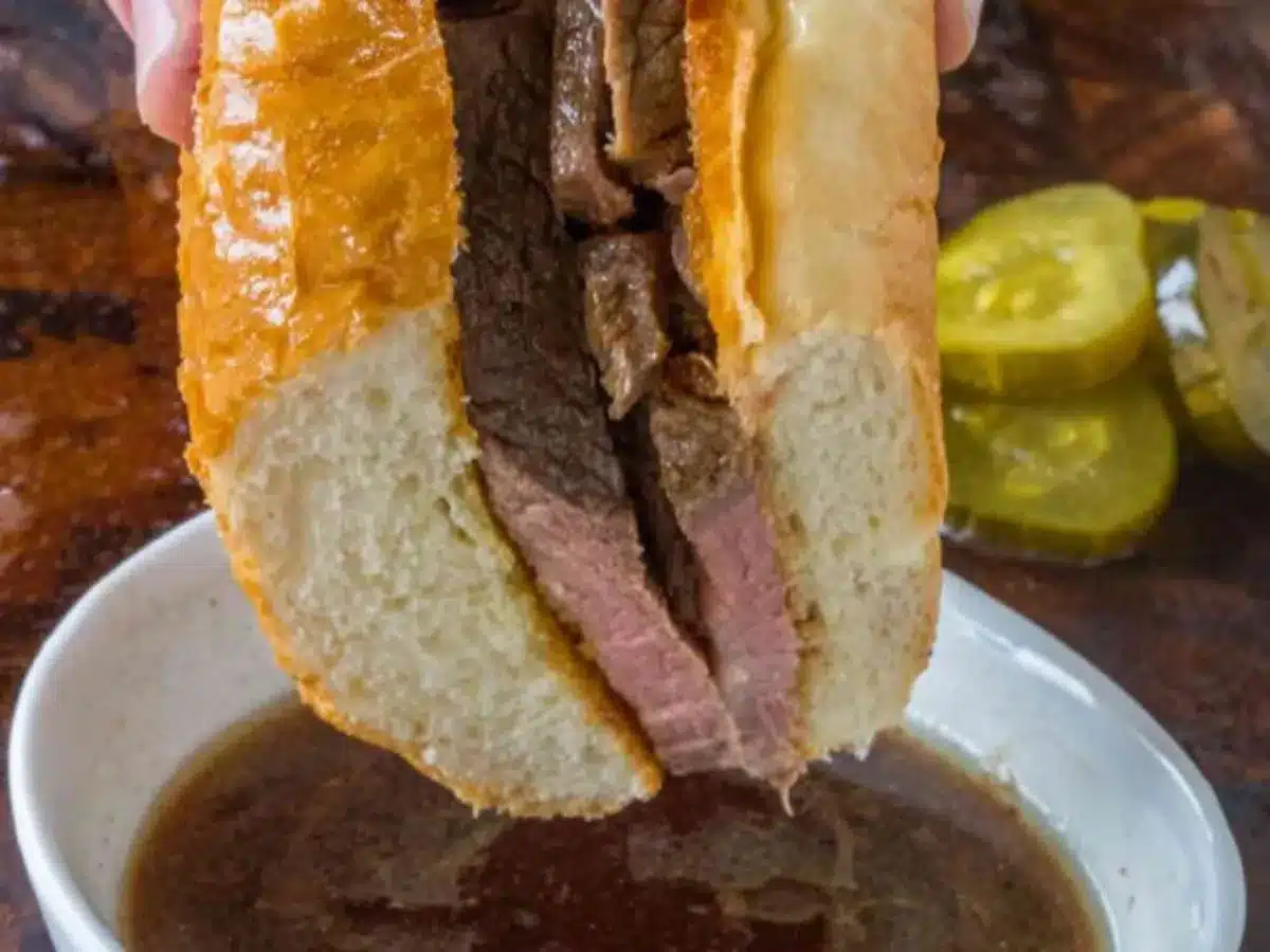 Beef sandwich in a soft white bun with dipping sauce