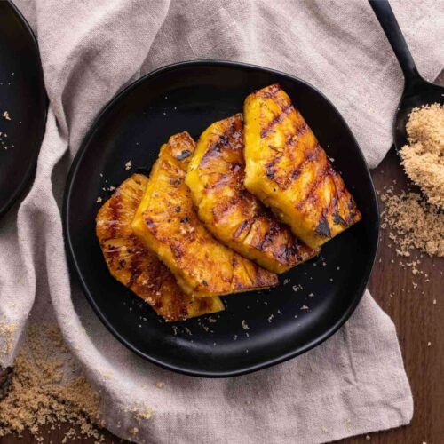 Brown Sugar Grilled Pineapple slices on plate