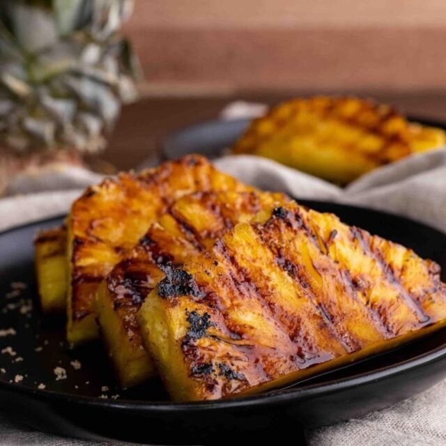 Brown Sugar Grilled Pineapple slices on plate