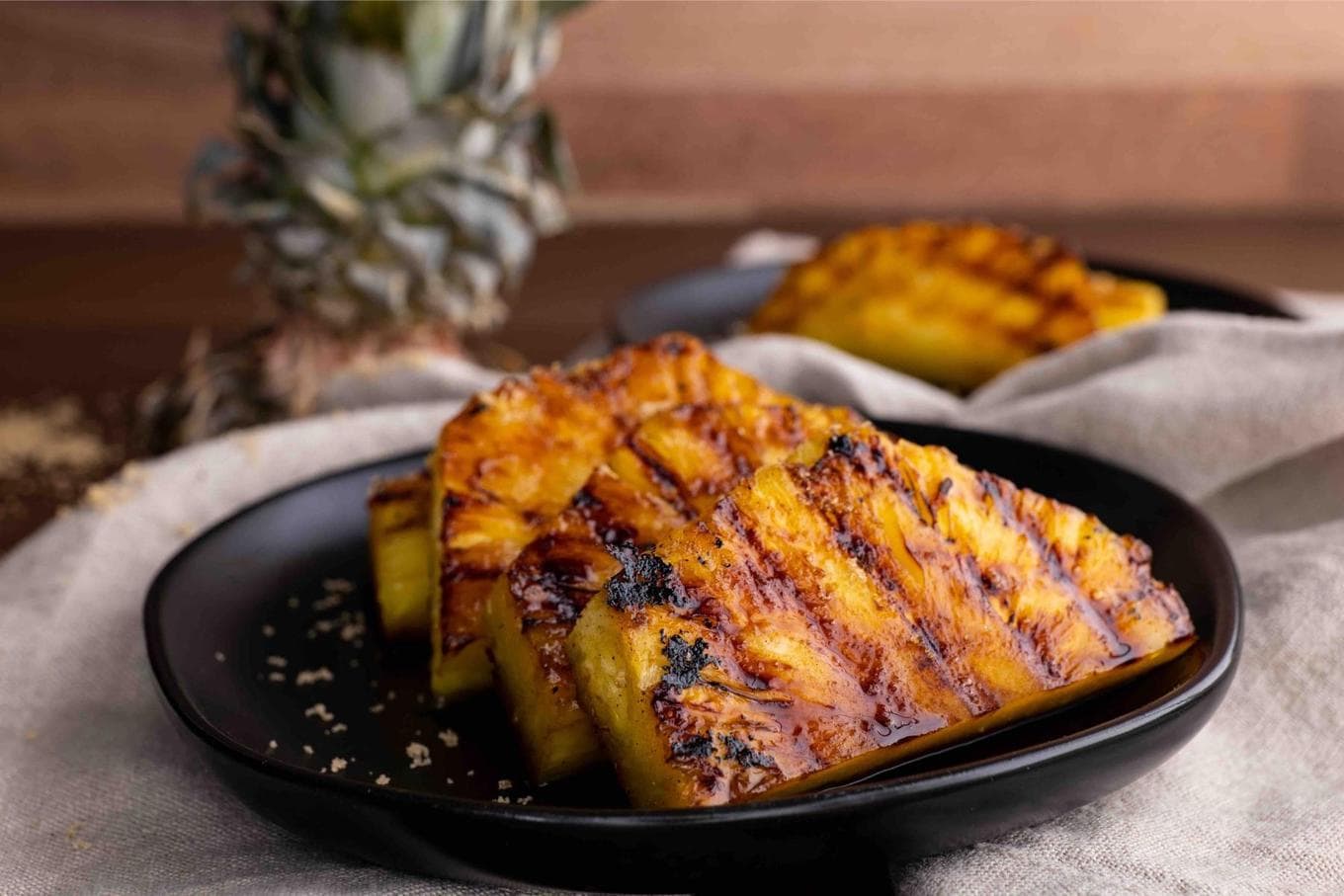Brown Sugar Grilled Pineapple slices on plate