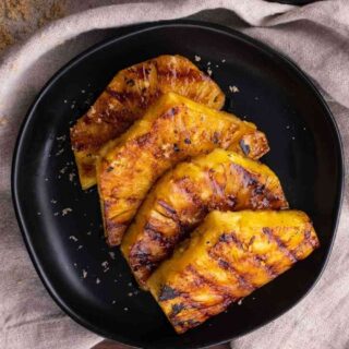 Brown Sugar Grilled Pineapple slices on plate