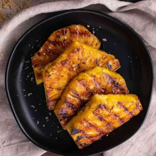Brown Sugar Grilled Pineapple slices on plate