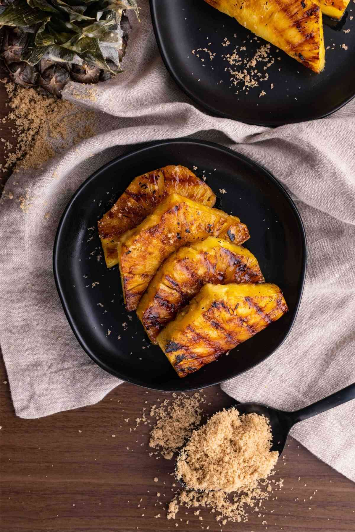 Brown Sugar Grilled Pineapple slices on plate