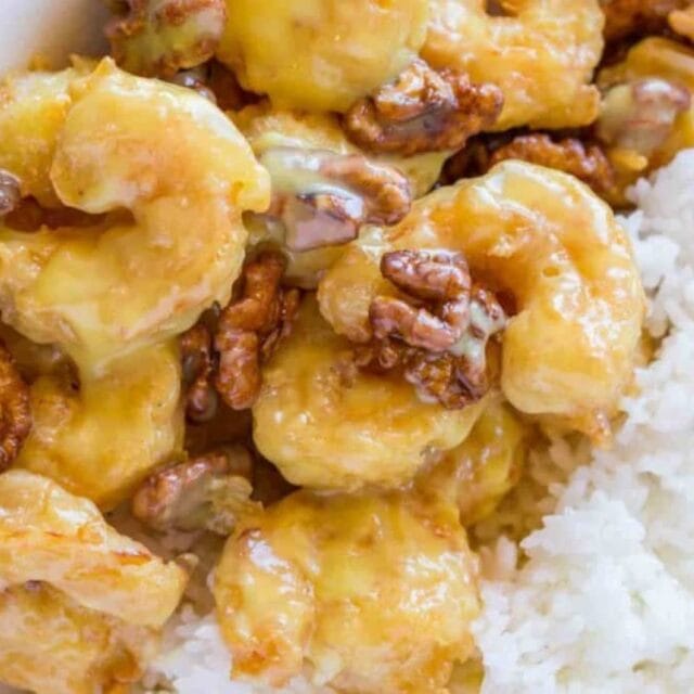 Fried shrimp and walnuts served over rice