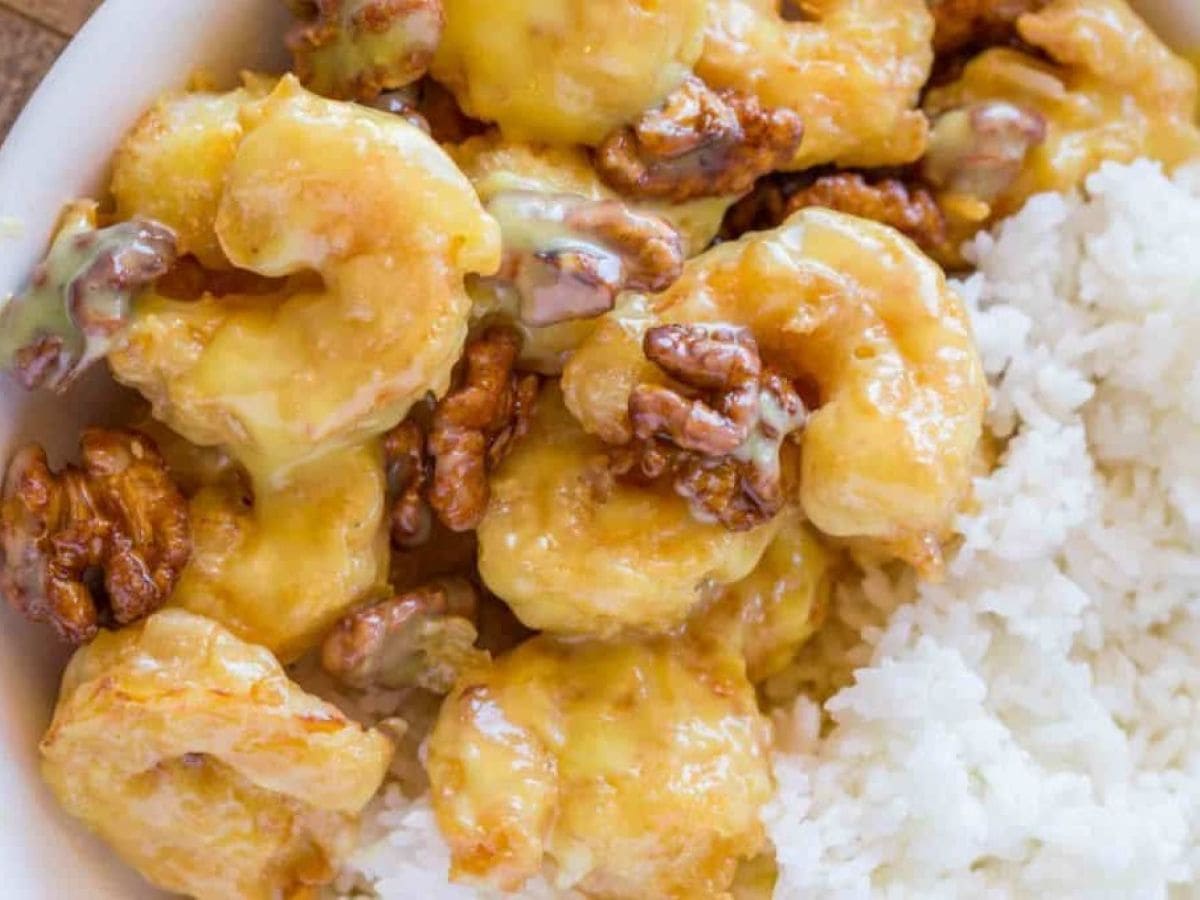 Fried shrimp and walnuts served over rice