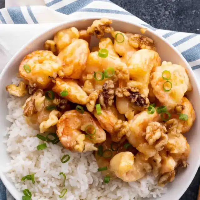 Seafood cooked with nuts with a side of rice