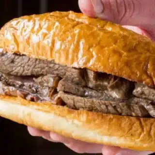 hand holding beef sandwich