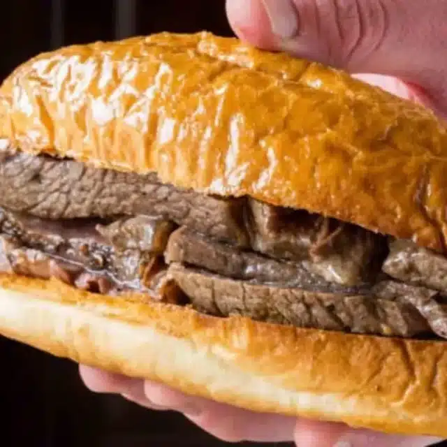 hand holding beef sandwich