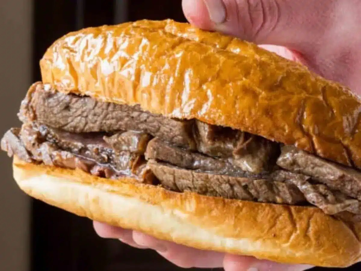 hand holding beef sandwich