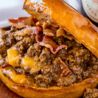 Prepared sloppy joe on plate with top bun slightly open to see filling