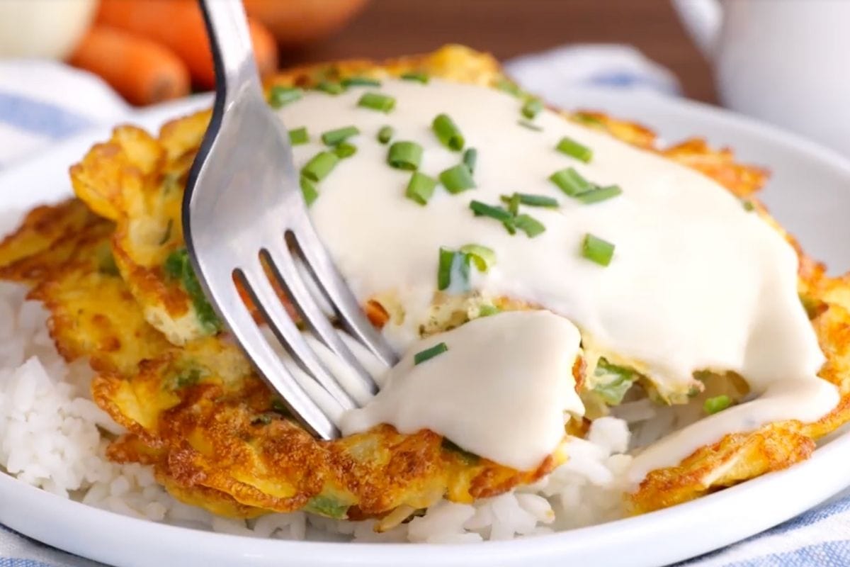 Egg Foo Young with gravy on plate with fork