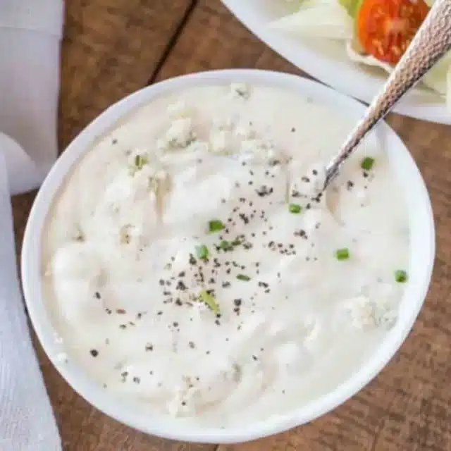 Bowl of dressing with spoon