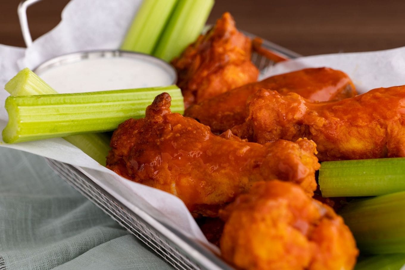 Buffalo Wings in basket with celery and ranch