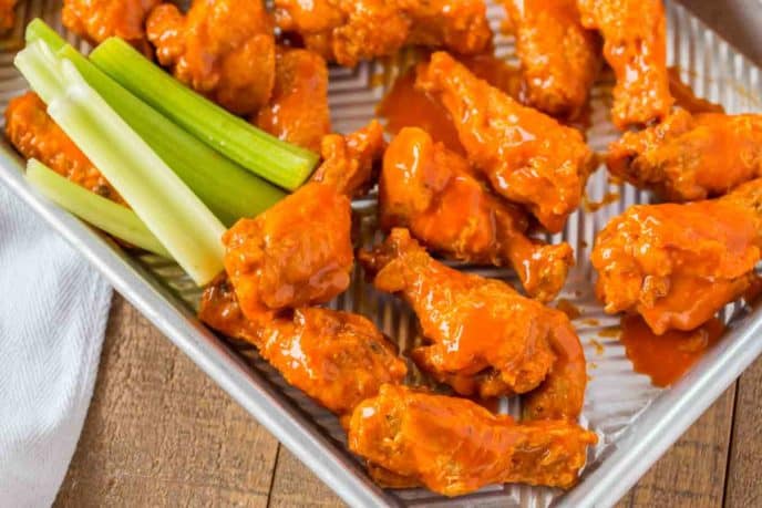 Buffalo Wings on baking sheet with celery