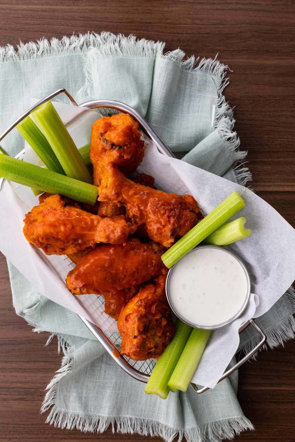 Buffalo Wings in basket with celery and ranch