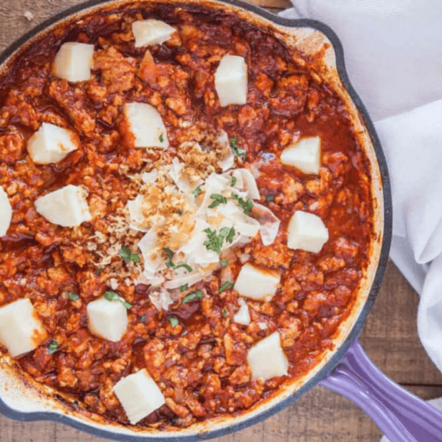 meat and sauce in a cast iron pan