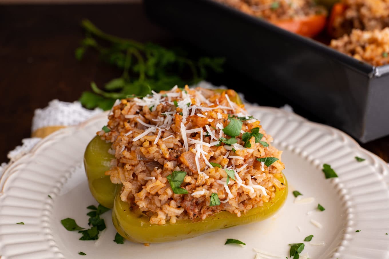 Stuffed Peppers on plate with parmesan & parsley