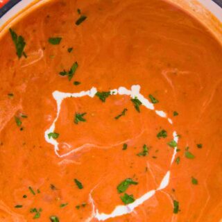 Soup in a pot with drizzle of cream on top