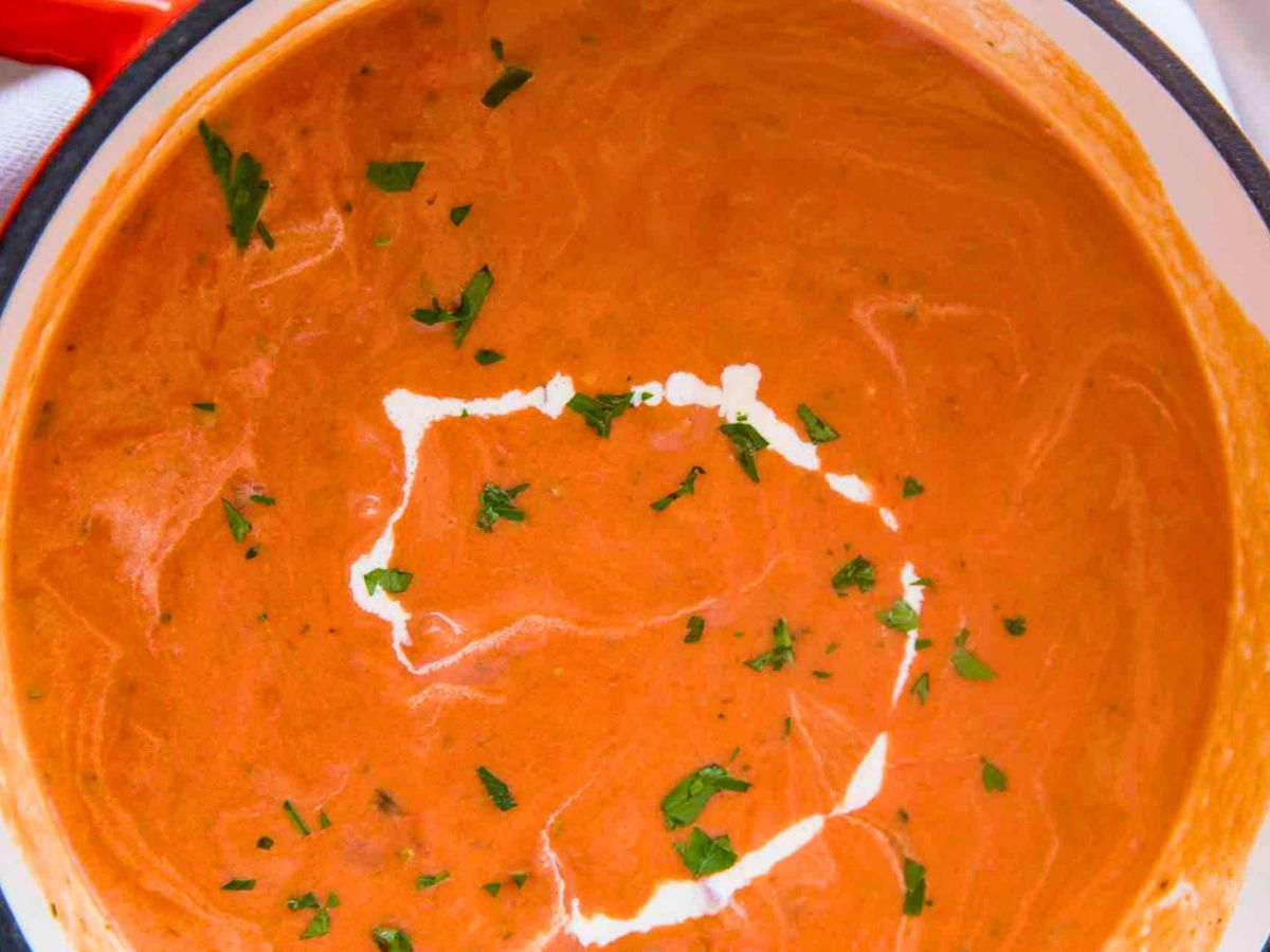 Soup in a pot with drizzle of cream on top