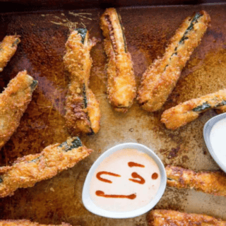 zucchini on baking sheet with dipping sauce