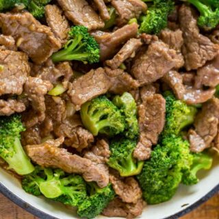 Cooked beef pieces and broccoli on plate.