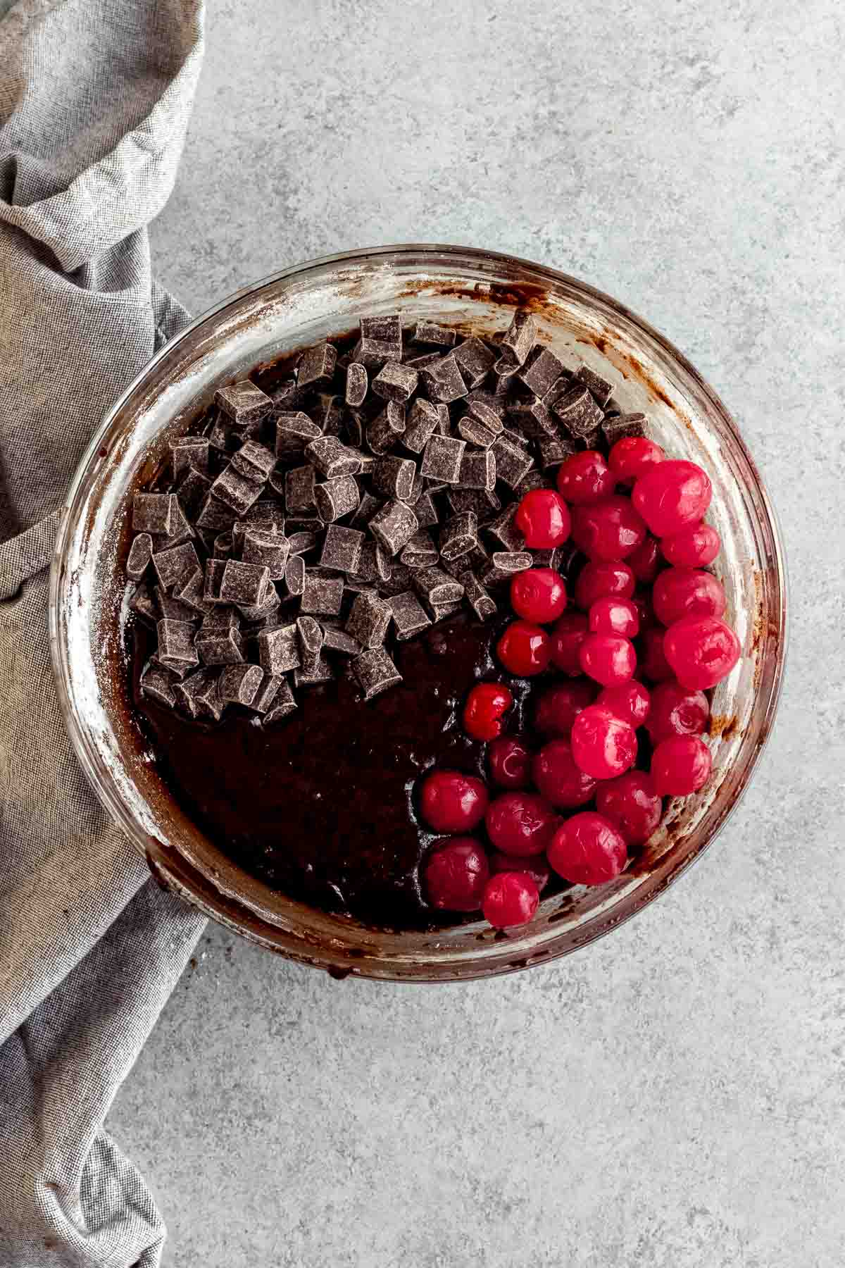 Chocolate chunks and cherries being mixed into Black Forest Brownie batter