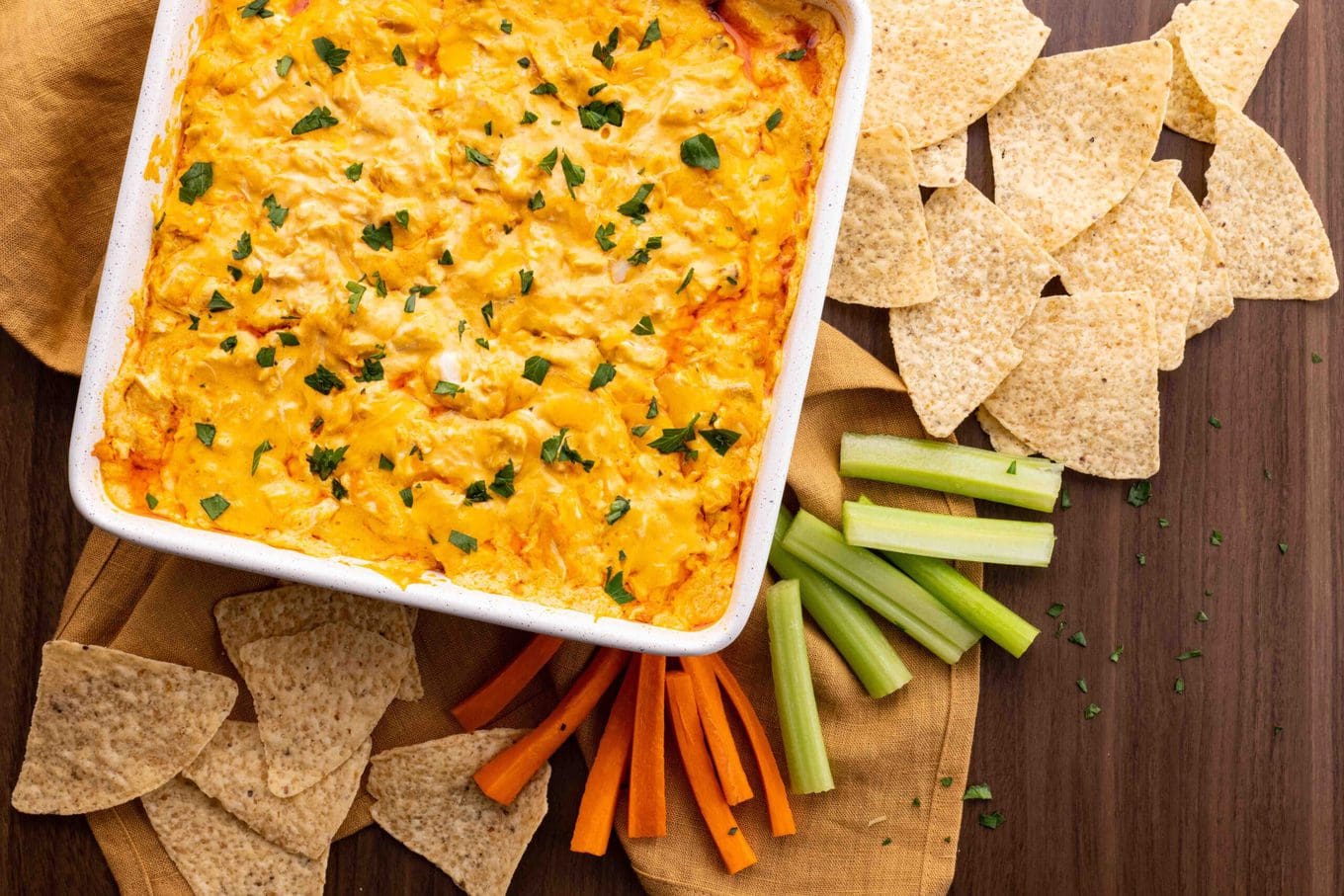 Buffalo Chicken Dip tastes just like buffalo wings dipped in ranch dressing with just five ingredients. No mess and all the flavors you love! Perfect for any holiday or Super Bowl party!