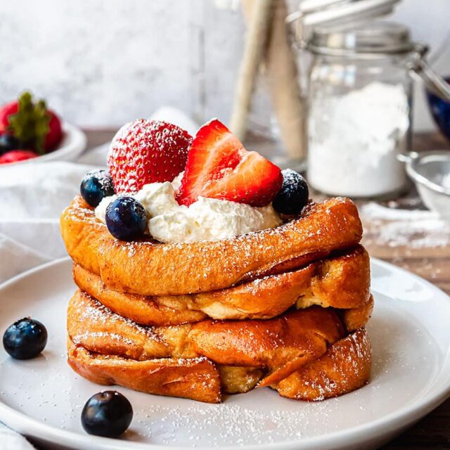 toasted bread on plate with strawberries and blueberries