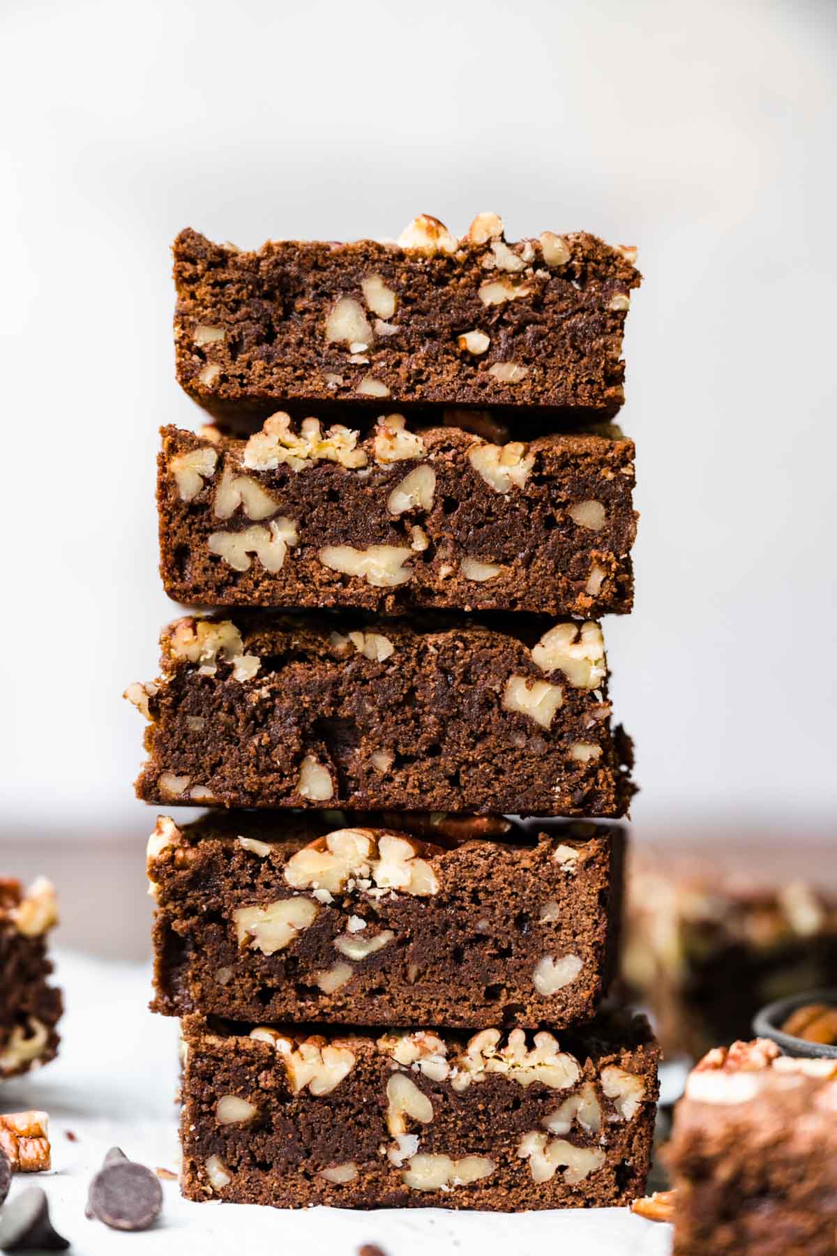 Pecan Brownies squares stacked on parchment
