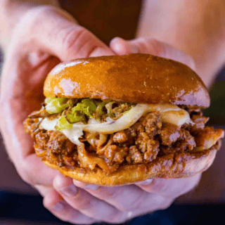 Hands Holding Sloppy Joes Sandwich with cabbage