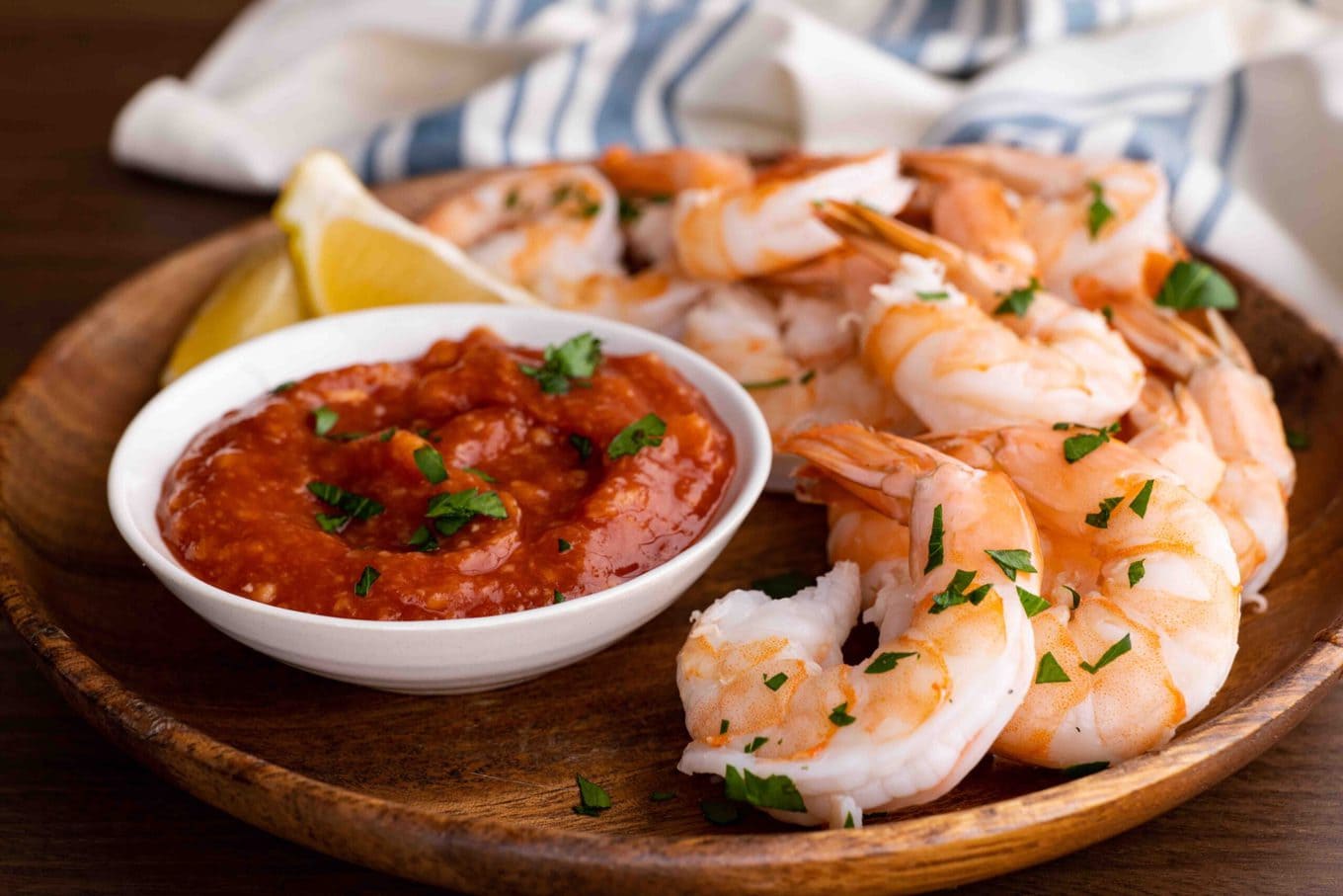 Shrimp Cocktail on serving plate with cocktail sauce and lemon wedges