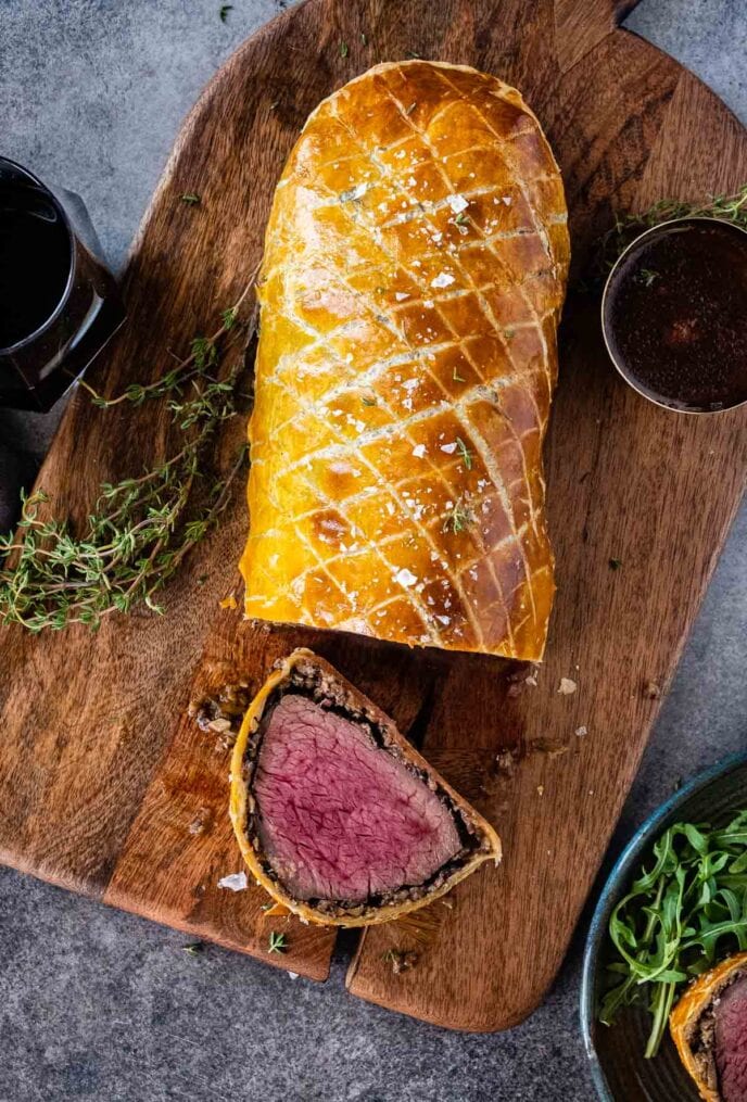 Beef Wellington fully cooked on cutting board